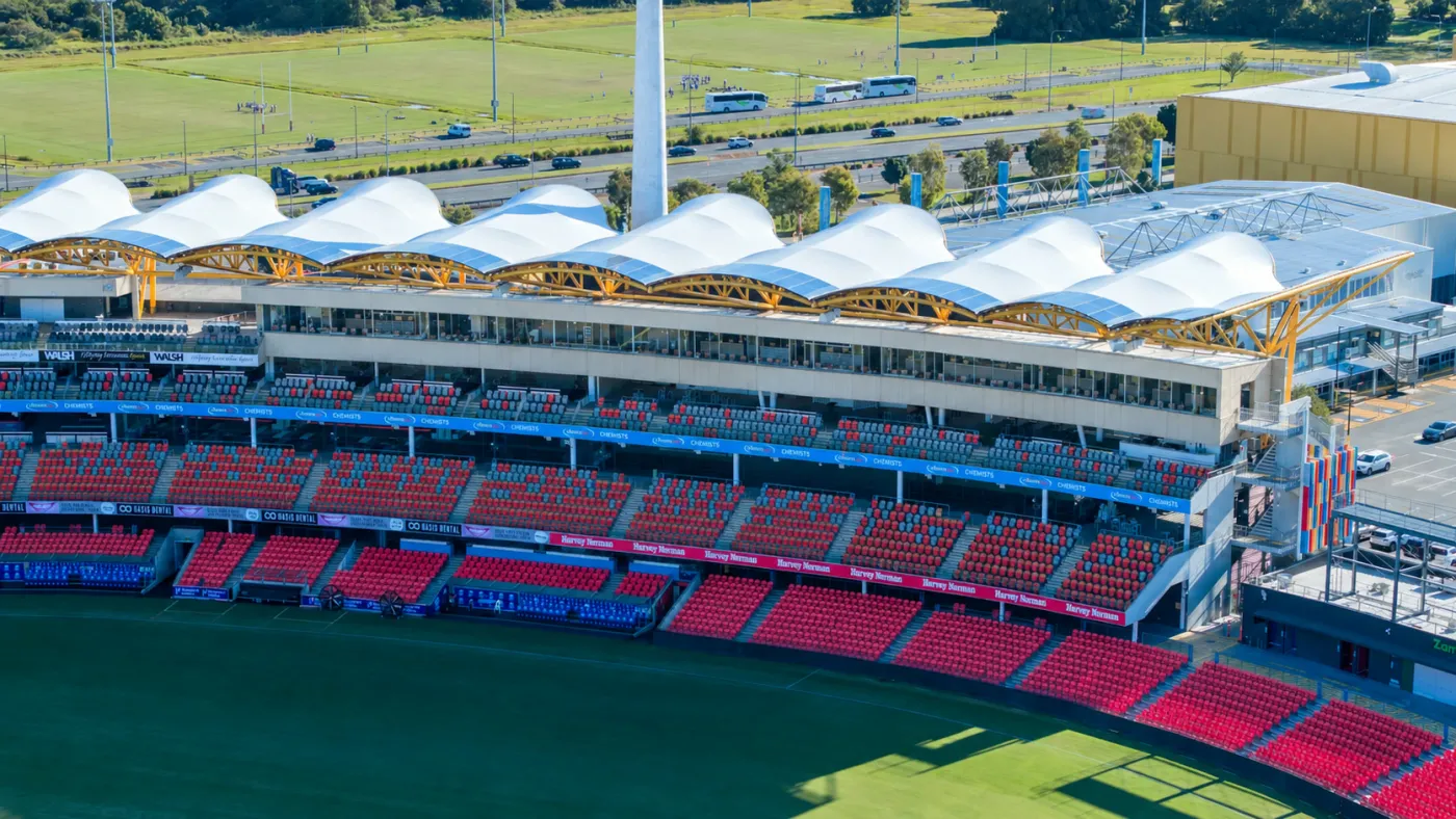 People First Stadium before the facade works: the bare concrete grandstand